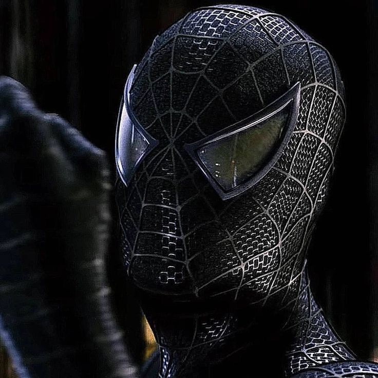 the amazing spider - man in black suit with yellow eyes