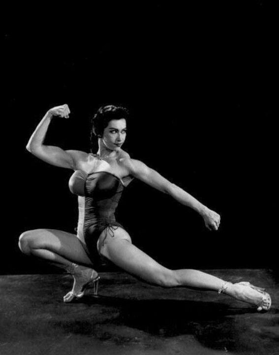 a black and white photo of a woman doing yoga