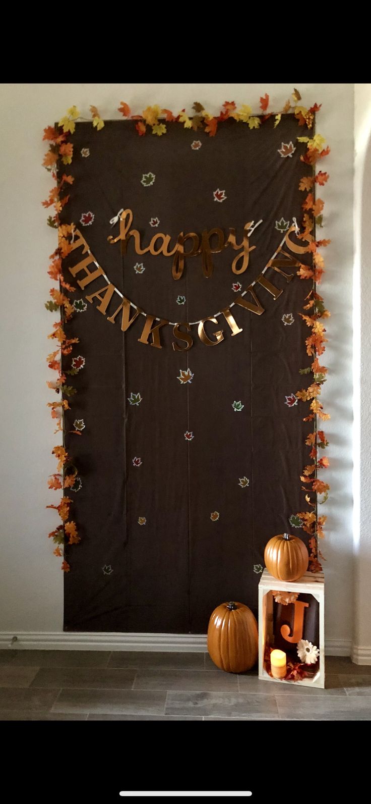 a happy halloween banner with pumpkins and other decorations on the wall behind it in front of a fireplace