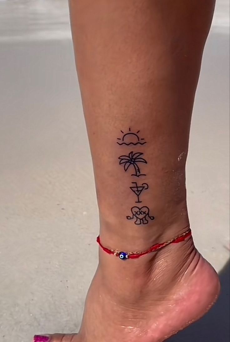 a woman's foot with a tattoo on it and the word sun, moon and palm trees