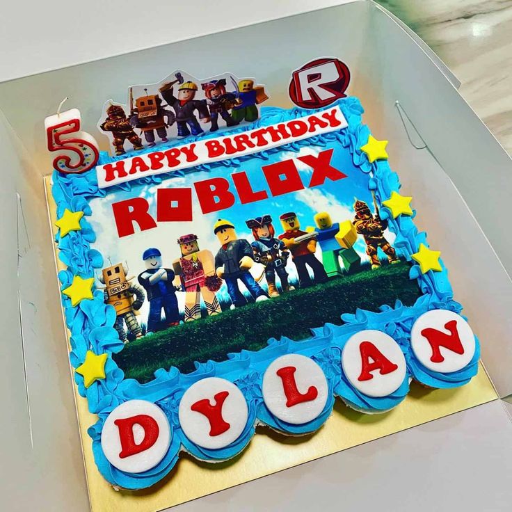 a birthday cake with the name robibox on it and characters in legoland