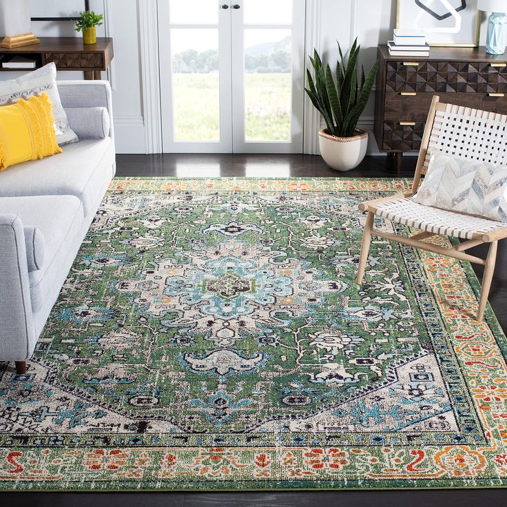 a living room with a couch, chair and rug