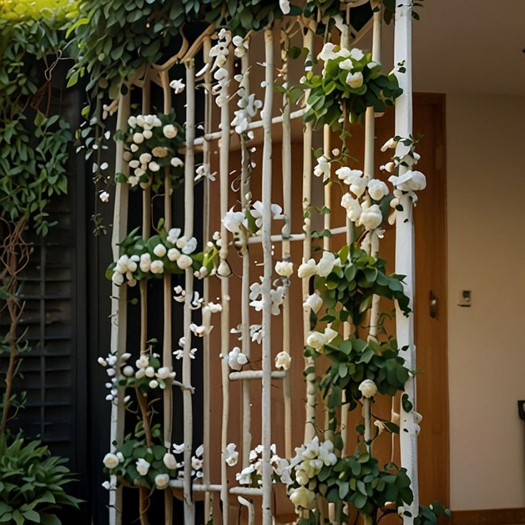 a white trellis with flowers and vines growing on it's sides in front of a door