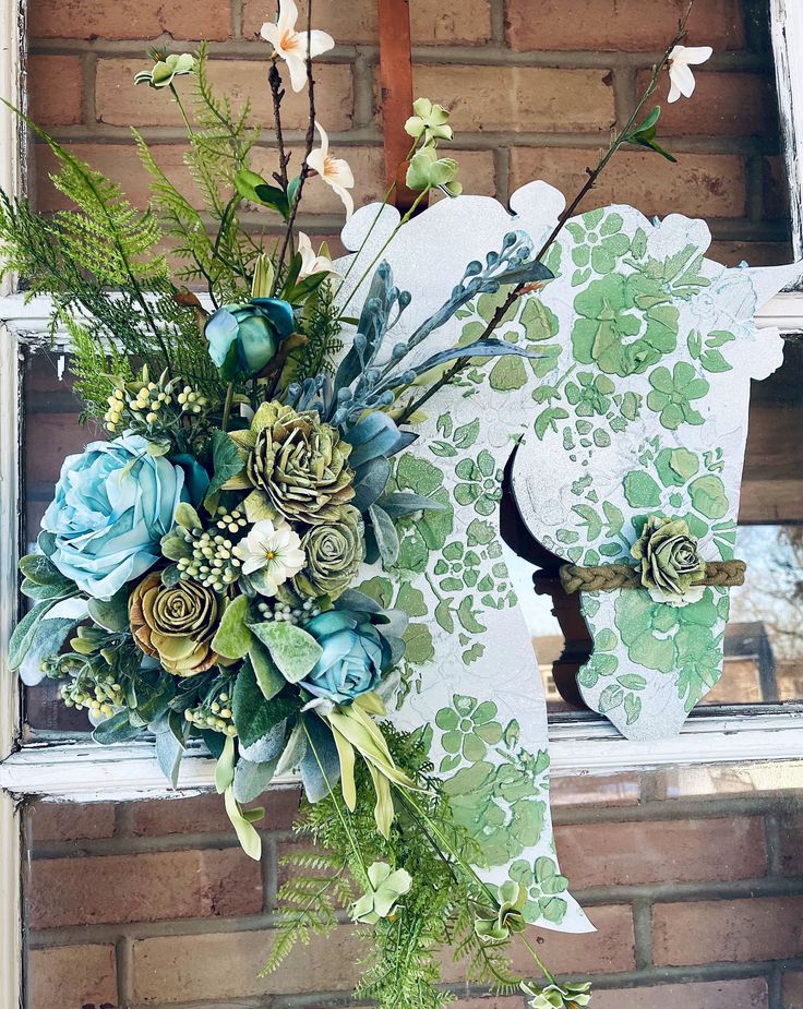 a bouquet of flowers sitting on top of a window sill in front of a brick wall