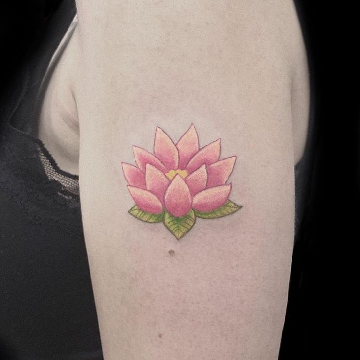 a woman's arm with a pink flower tattoo on the left side of her body