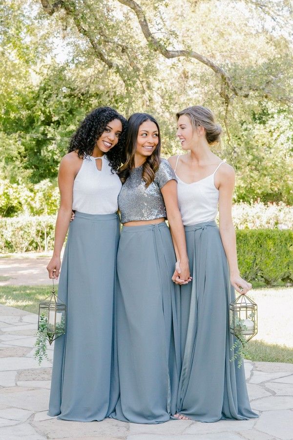 three women standing next to each other in dresses