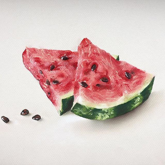 two slices of watermelon and seeds on a white surface