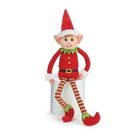 a stuffed toy elf sitting on top of a white cup with red and green striped stockings