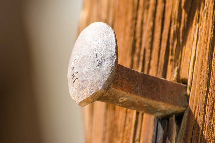 an old wooden door with a metal handle