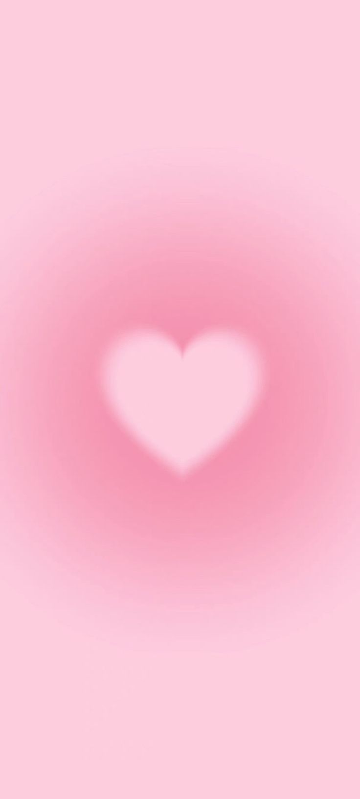 a heart shaped object is shown in the middle of a blurry pink background,