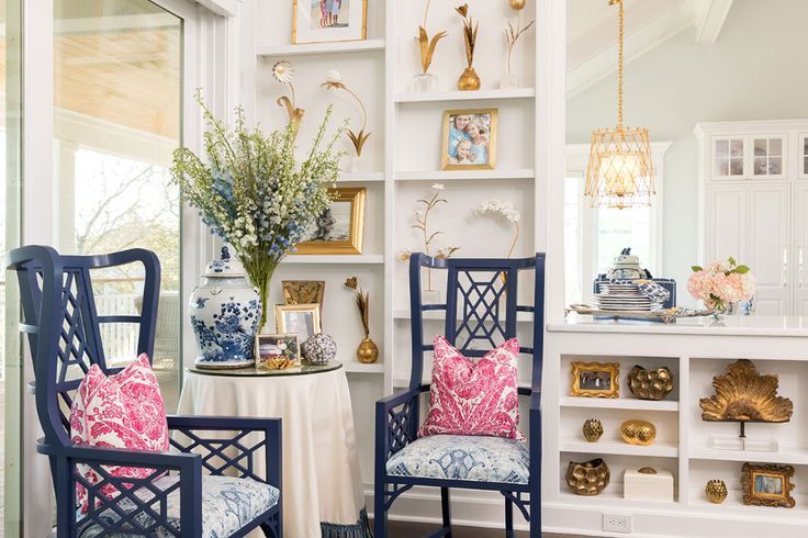 two blue chairs sitting next to each other on top of a hard wood floored floor