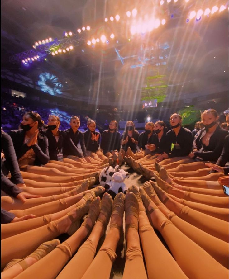 a large group of people sitting in front of giant stuffed animals