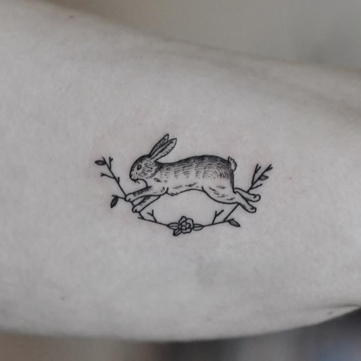 a small rabbit tattoo on the arm