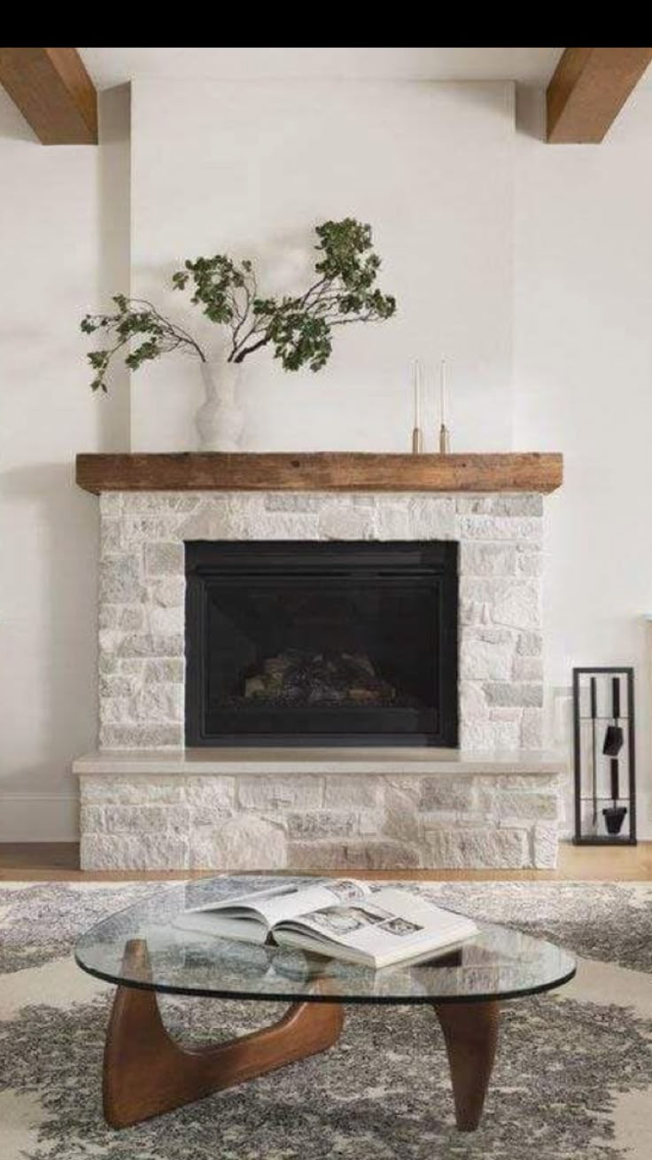 a living room with a fire place and a glass table in front of the fireplace