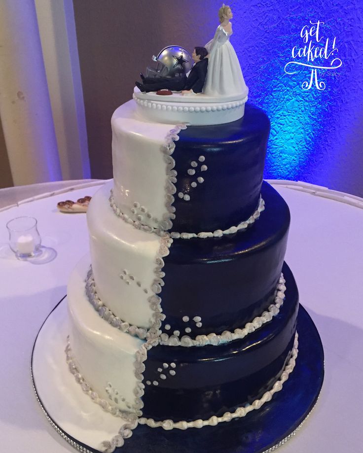 a blue and white wedding cake on top of a table