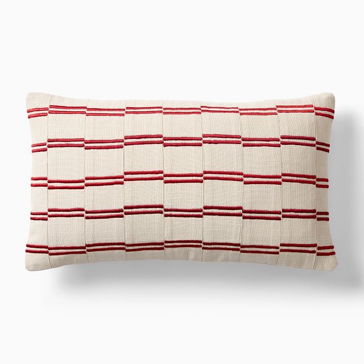 a red and white striped pillow on a white background