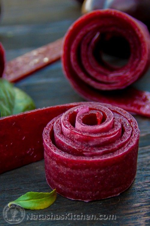 rolled up beets sitting on top of a wooden table