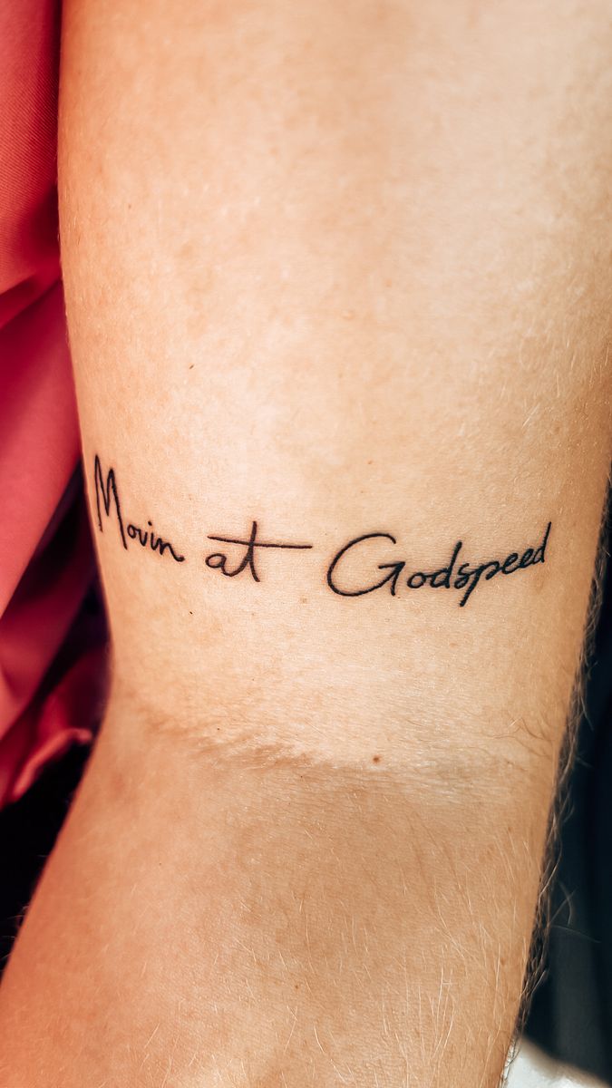 a man with a tattoo on his arm that says, mum at godlyed