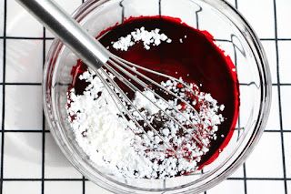 a glass bowl filled with red and white food