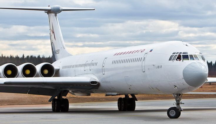 an airplane is sitting on the runway with its wheels down