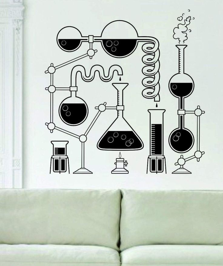 a living room with a couch and wall decal that has various types of lab equipment on it