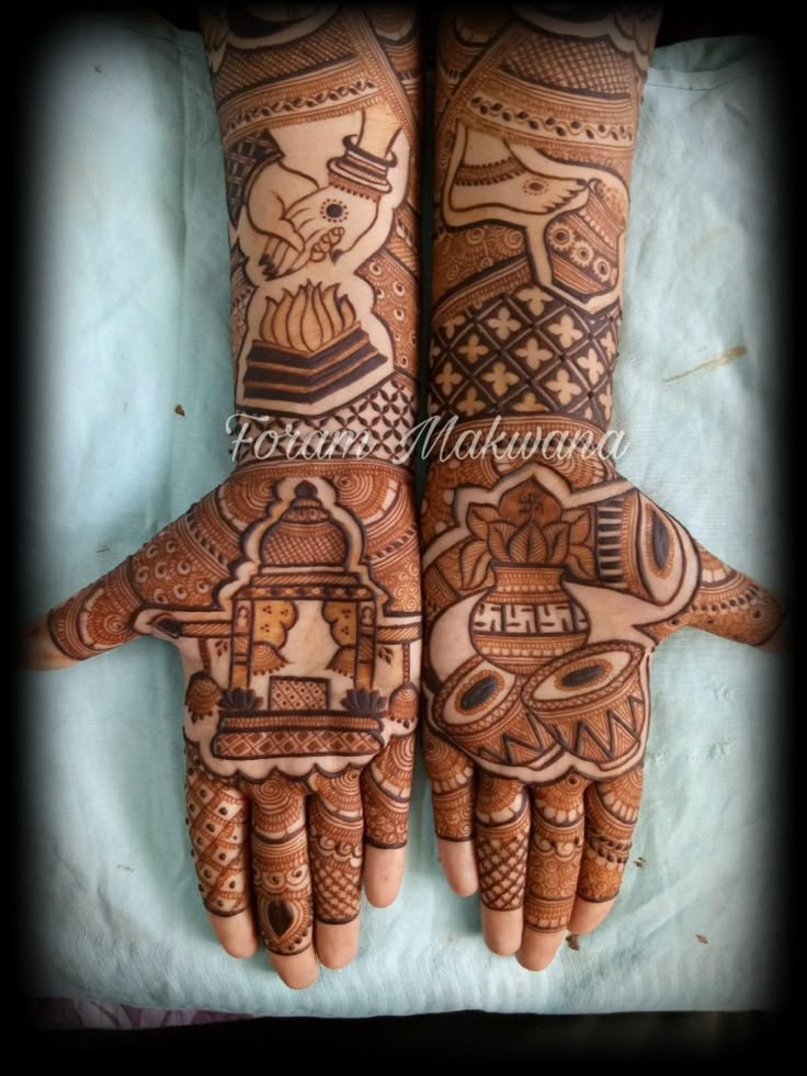 two hands with henna designs on them