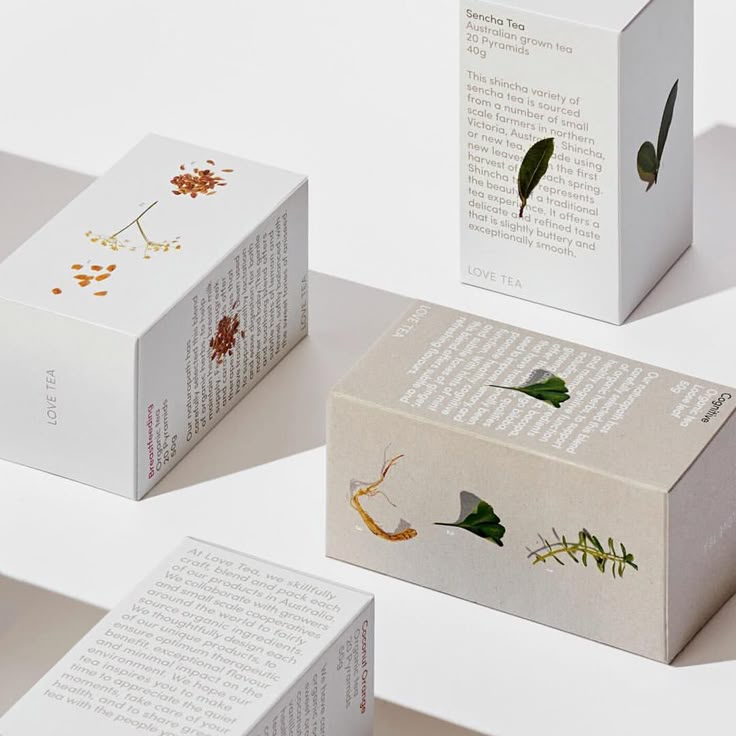 three boxes with designs on them sitting next to each other in front of a white background