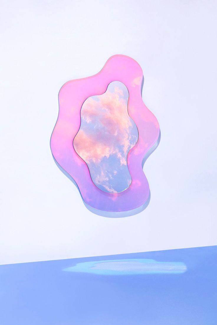 a pink and blue object with clouds in the background