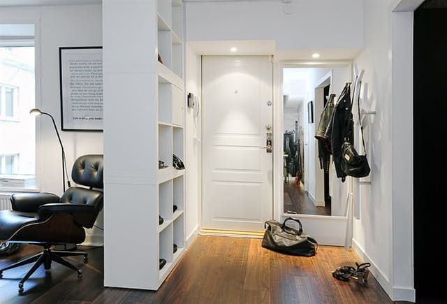 there is a shoe and handbag on the floor in this room with white walls