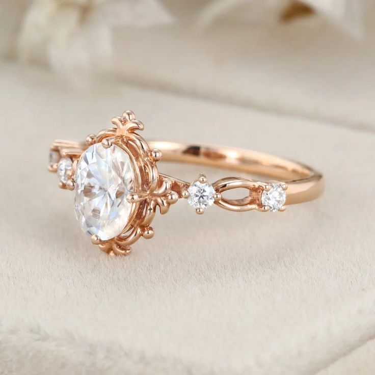 a rose gold engagement ring with an oval cut diamond