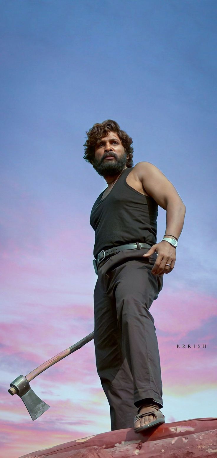 a man standing on top of a rock with an ax