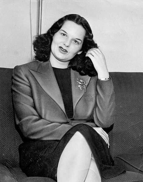 black and white photograph of a woman sitting on a couch