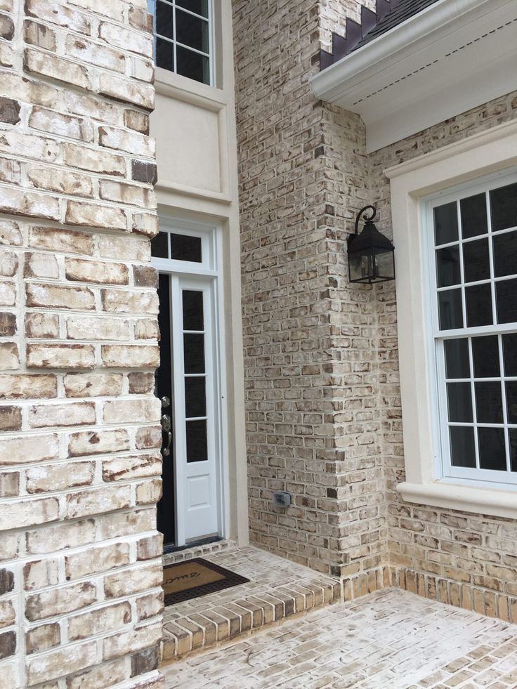 a brick building with two white doors and windows