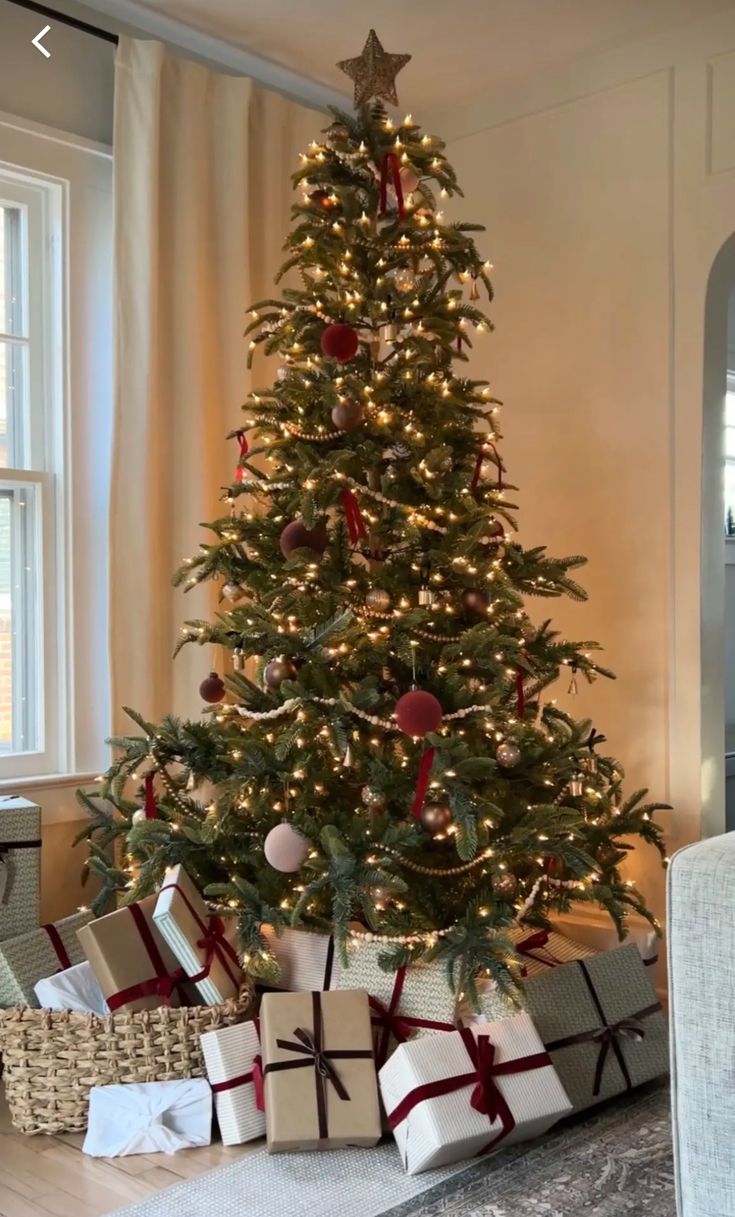 a small christmas tree with presents under it