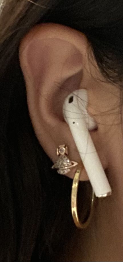 a close up of a person with ear piercings and an object in their ear