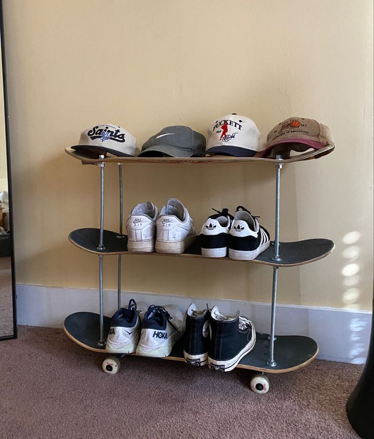 there is a skateboard and several pairs of shoes on the shelves in this room