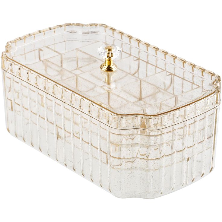 a clear glass box with a gold handle on it's lid and a small knob in the middle