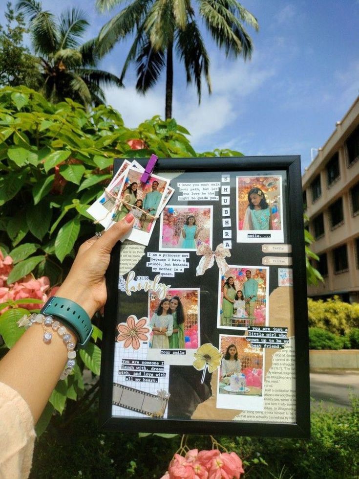 a person holding up a poster with pictures on it in front of some flowers and palm trees