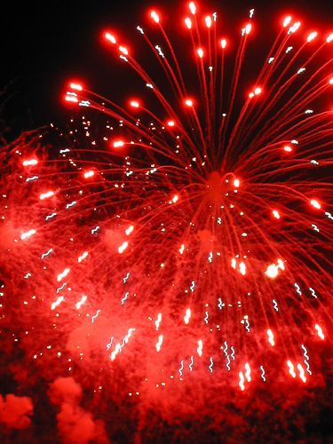 red fireworks are lit up in the night sky