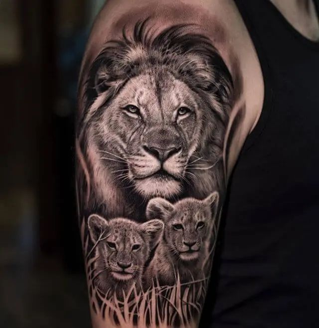 a man with a lion and cubs tattoo on his arm