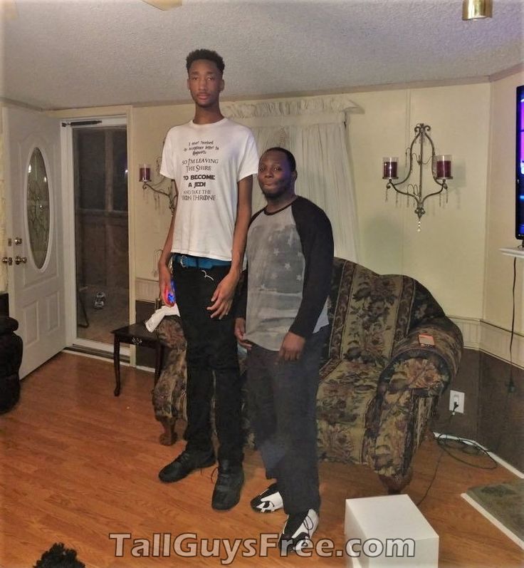 two young men standing in a living room