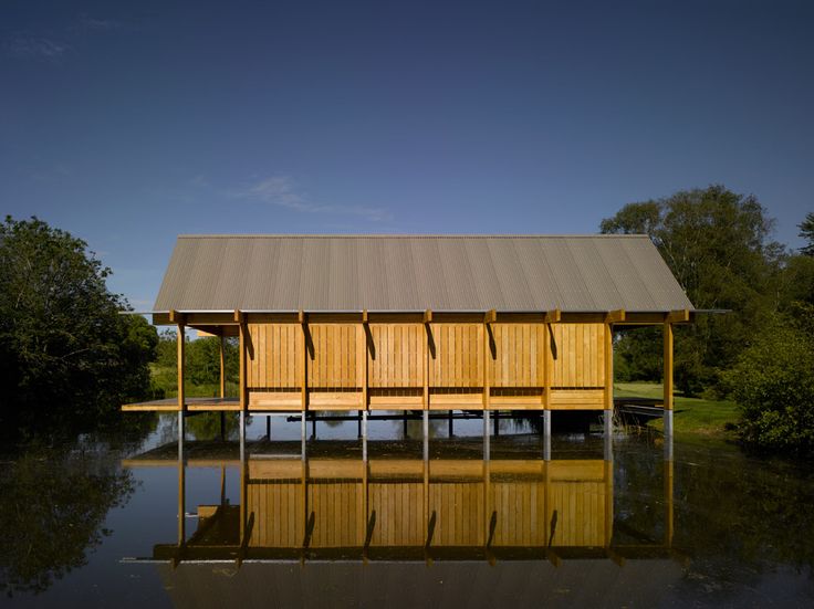 a wooden boathouse sitting on top of a lake