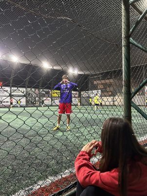 a person standing in front of a soccer goal