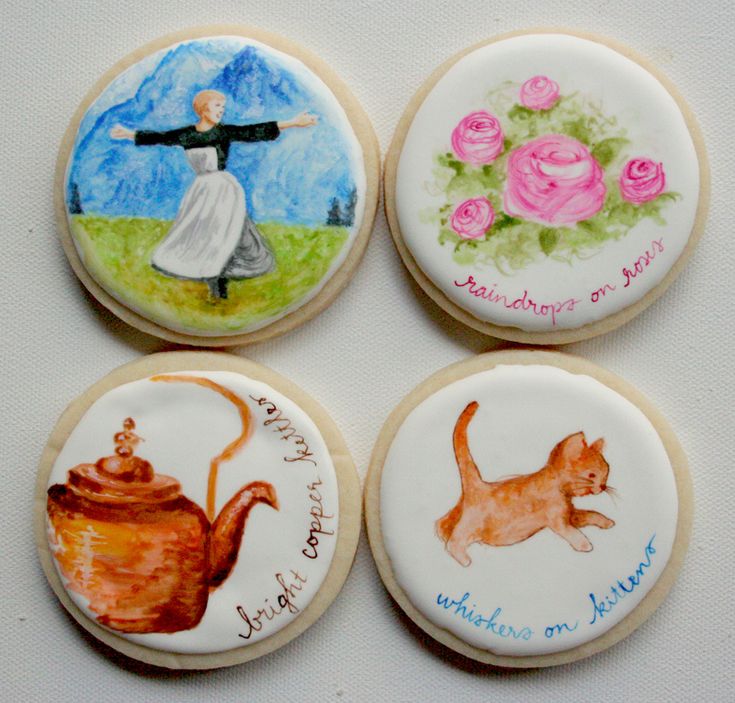 four decorated cookies with images of women and cats