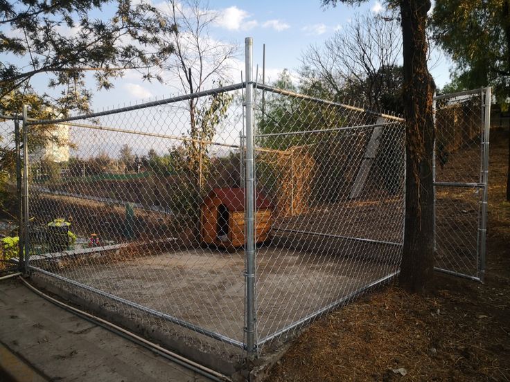 a fenced in area with a truck behind it