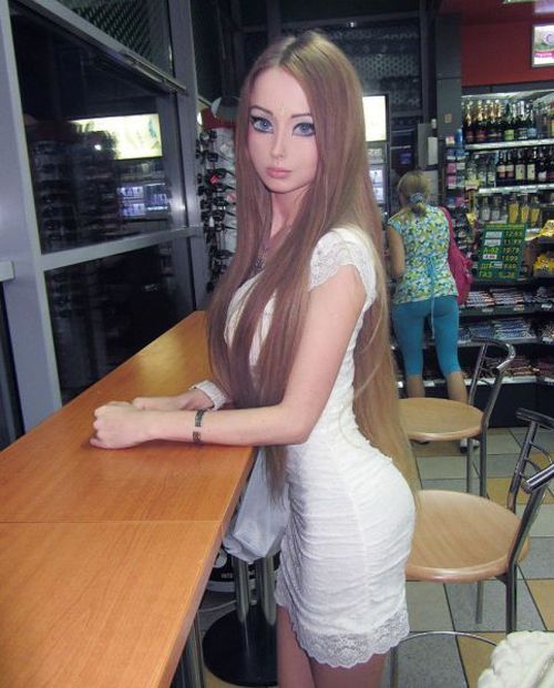 a woman with long hair standing at a counter