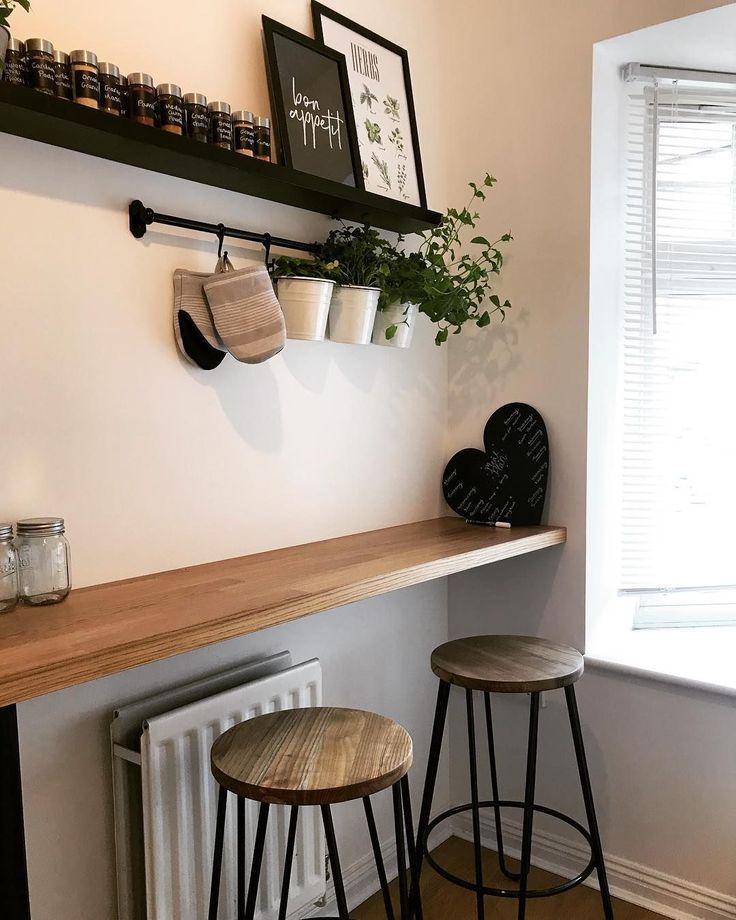 two wooden stools sitting next to each other in front of a wall mounted radiator