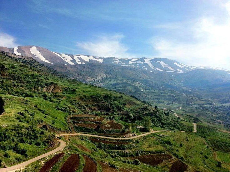 an aerial view of a winding road in the mountains