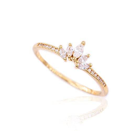 a yellow gold ring with three diamonds on the top and bottom, set against a white background