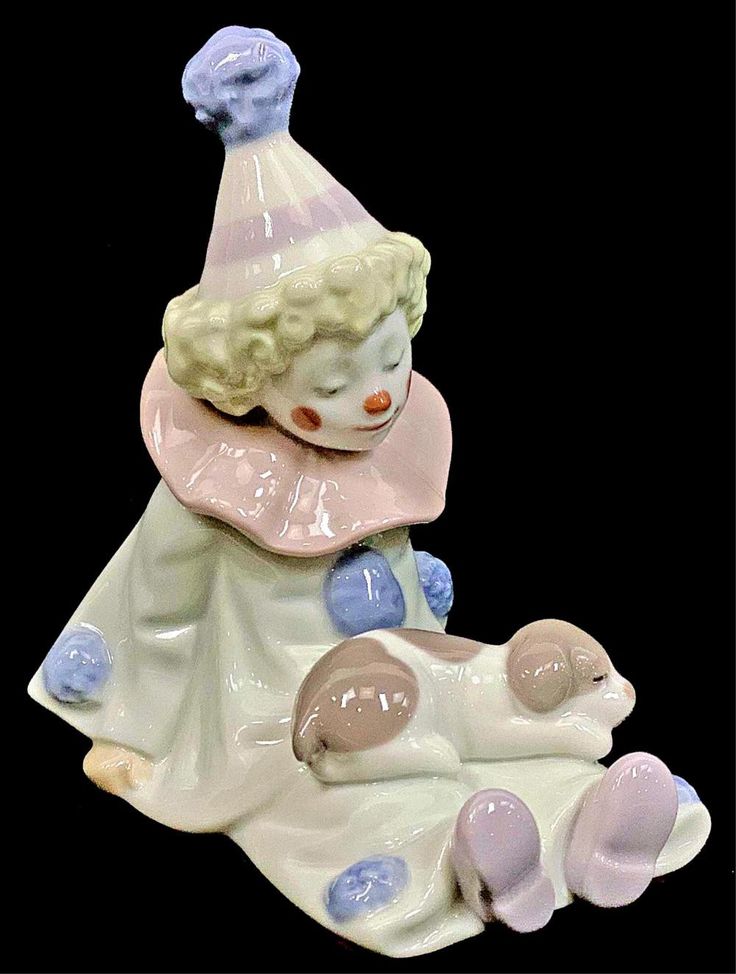 a ceramic figurine with a clown hat on it's head